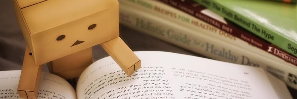 Cardboard robot reading a law book